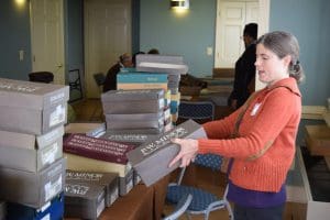 Volunteer Teresa Savarino helped distribute orthopedic shoes to Regency House residents at a special pop-up market. Iona received close to 300 pairs of shoes from Public Shoe Store in Arlington.